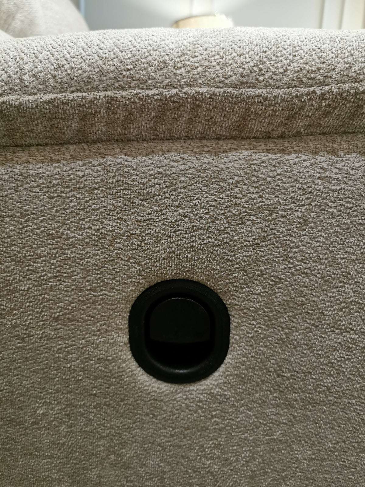 Close-up of beige fabric from the 727 Brooks Reclining Loveseat by La-z-boy, featuring a central round black button.