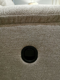 Close-up of beige fabric from the 727 Brooks Reclining Loveseat by La-z-boy, featuring a central round black button.