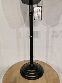 The "Crestview Collection" Rattan Floor Lamp adds a modern touch with its black metal stand and round wooden base.