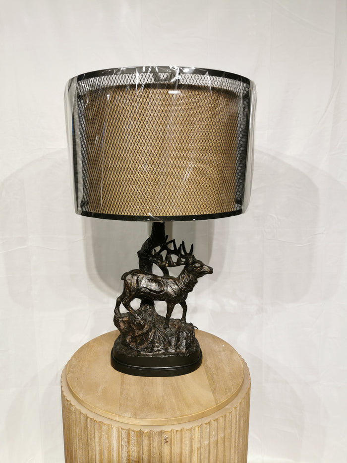 Hunters Walk Table Lamp: elk-themed base, cylindrical shade, on a round wooden pedestal by Crestview Collection.