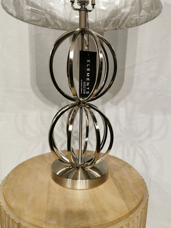 The Metal 30" Table Lamp by Crestview Collection, with a chrome base and round shade, elevates your decor on wood.