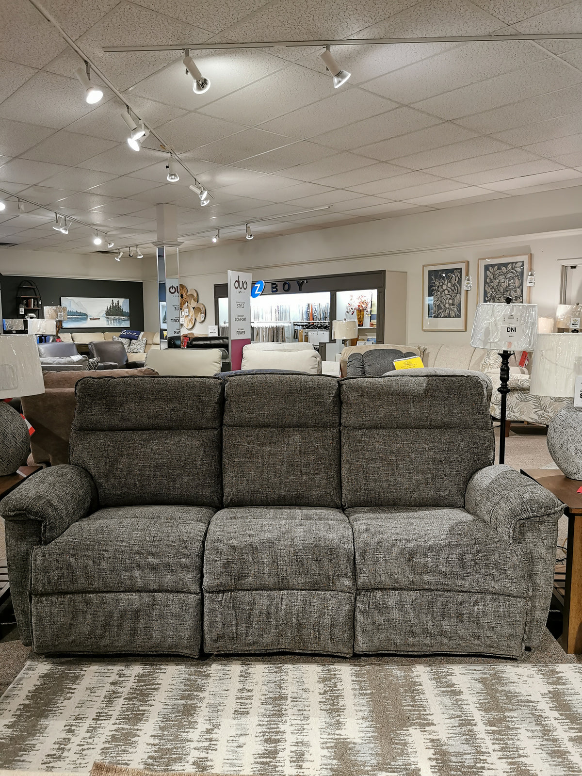 La-z-boy's 706 Jay Sofa with chaise legrests showcased in a stylish showroom with elegant home decor.