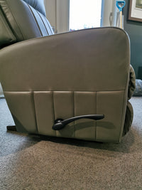 Close-up of the La-Z-Boy 747-10 Finley Leather Rocker Recliner, highlighting comfort, on a carpeted floor by a windowed wall.