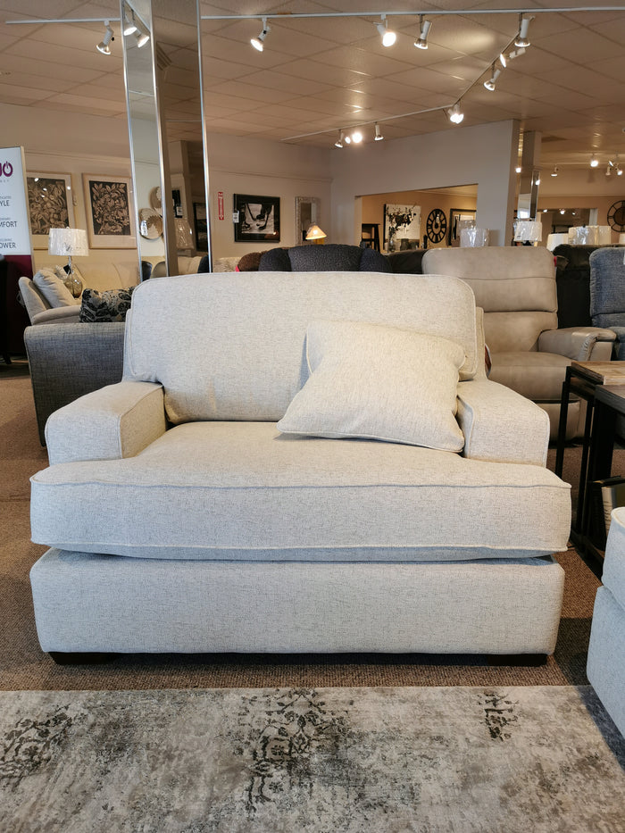 Experience the La-Z-Boy Paxton Chair & 1/2: a beige armchair with ComfortCore® cushions and matching pillow for relaxation.