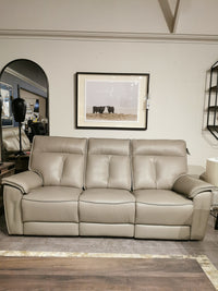 A Palliser 41187 Oakley Zero Gravity power sofa in a modern living room with a framed cow photo above it.