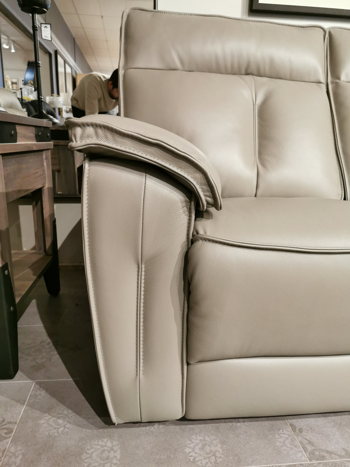 Palliser's 41187 Oakley recliner with power headrest in a showroom, near a wooden table and mirrored wall.