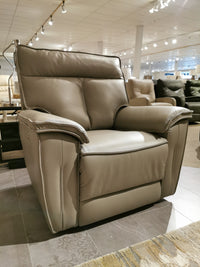 The Palliser 41187 Oakley Zero Gravity Power Recliner in gray leather with wall-hugger tech is showcased in a bright showroom.