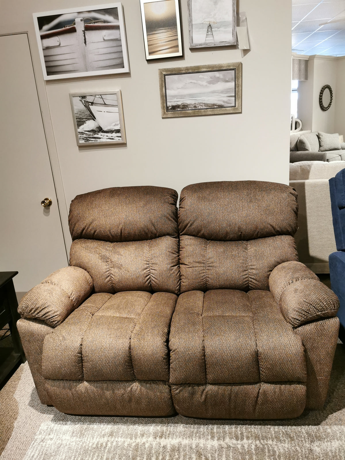 A La-Z-Boy 766 Morrison Power Reclining Loveseat in a cozy room, with framed art and a plush adjustable-legrest sofa.