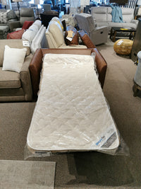 The Bayment Chair Sofa Bed by Best, featuring a twin-size and memory foam mattress, is on display in the store showroom.