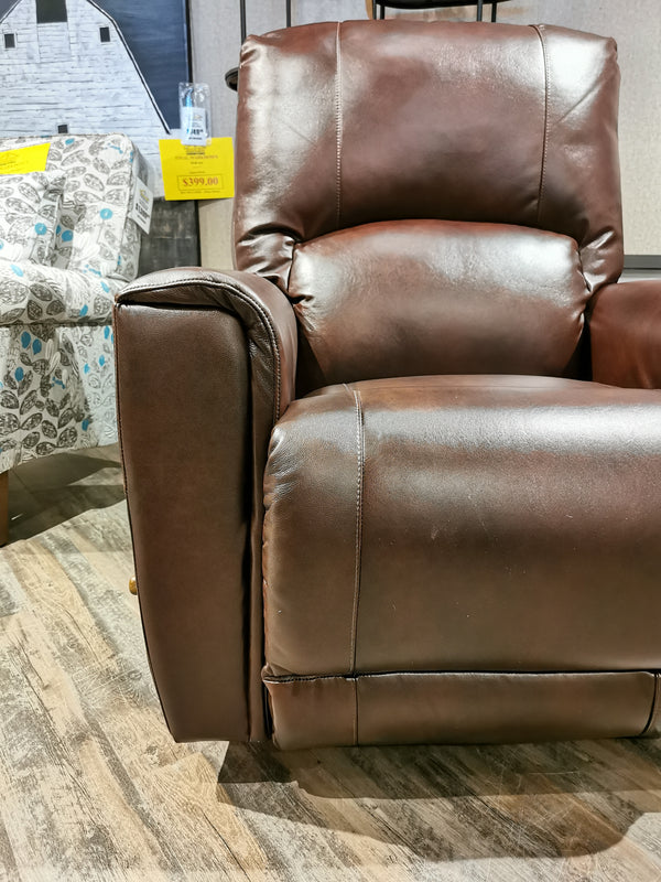 802 Cassian Rocker Recliner by La-z-boy displayed in showroom, patterned fabric chair seen behind.