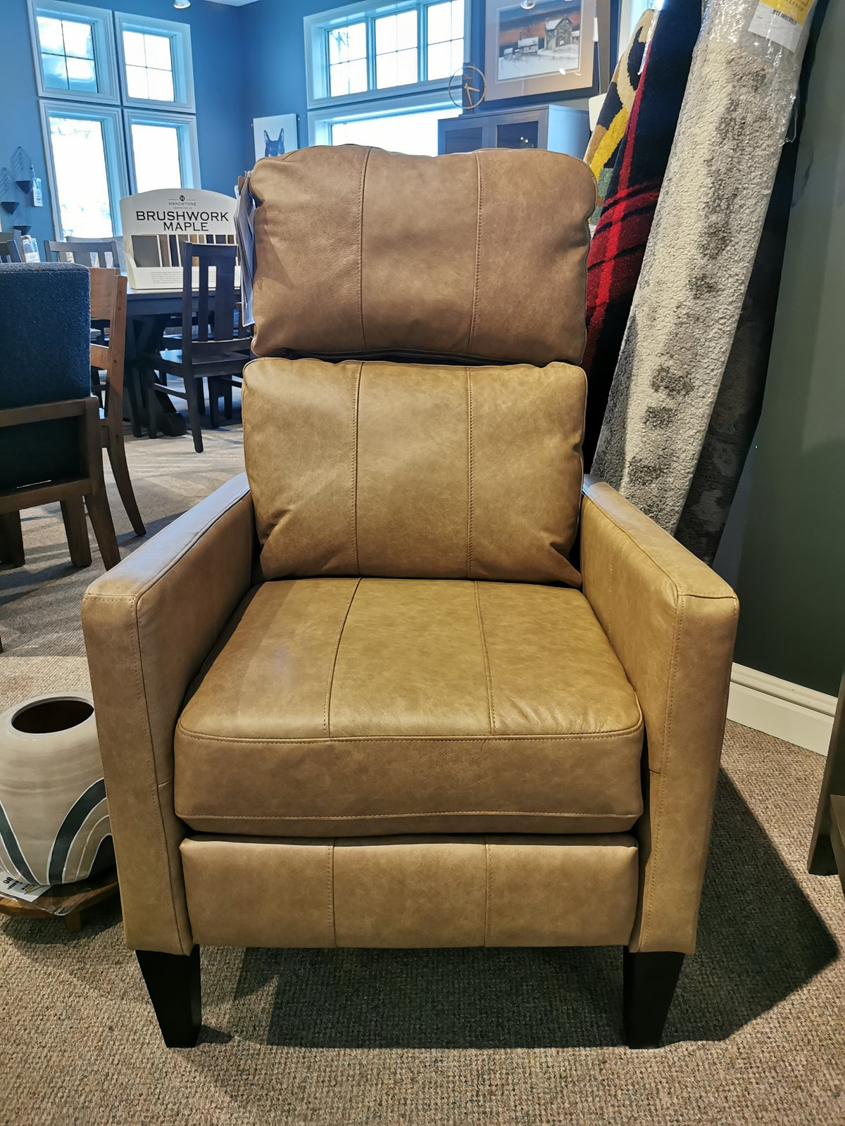 The 53559 Janae Power Chair by Best, a sleek brown leather recliner with a high backrest, is in the showroom.