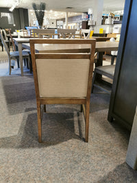 Winston Dining Package featuring a rustic finish wooden chair with an upholstered back from Donald Choi in showroom.