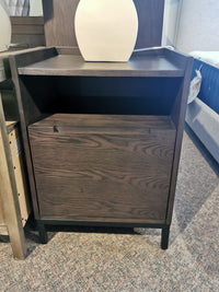 Hanson Charcoal Nightstand by Donald Choi, featuring ash veneer and closed drawer, on a carpeted floor.