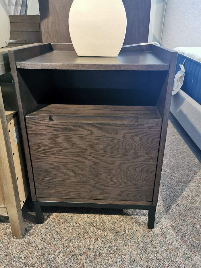 Hanson Charcoal Nightstand by Donald Choi, featuring ash veneer and closed drawer, on a carpeted floor.