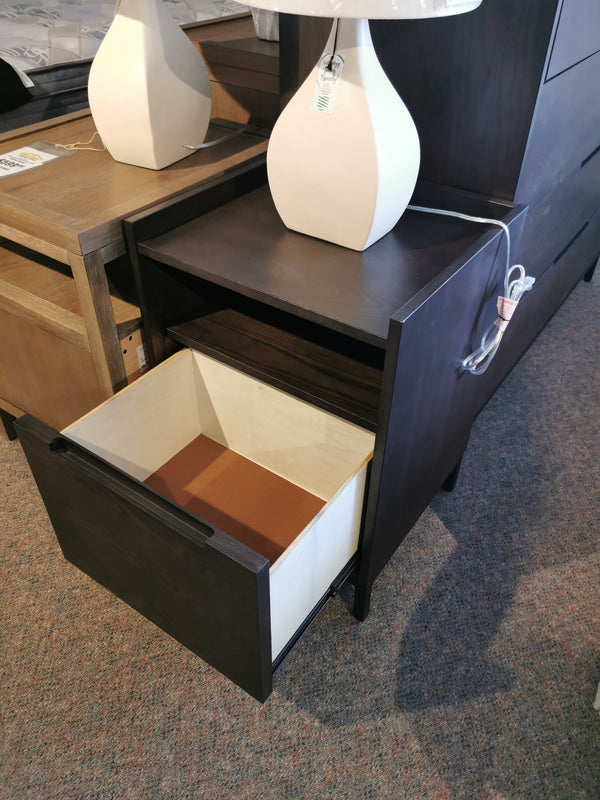 Donald Choi's Hanson Charcoal Nightstand with an open drawer and a lamp on top reveals the carpet below.