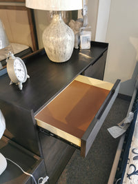 Hanson Charcoal Dresser by Donald Choi showcases an open drawer, lamp, and clock on top; charcoal finish adds elegance.