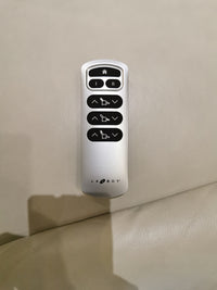 Silver remote for the 787 Lennon Power Rocker Recliner by La-Z-Boy, with buttons to adjust positions for oversized comfort.