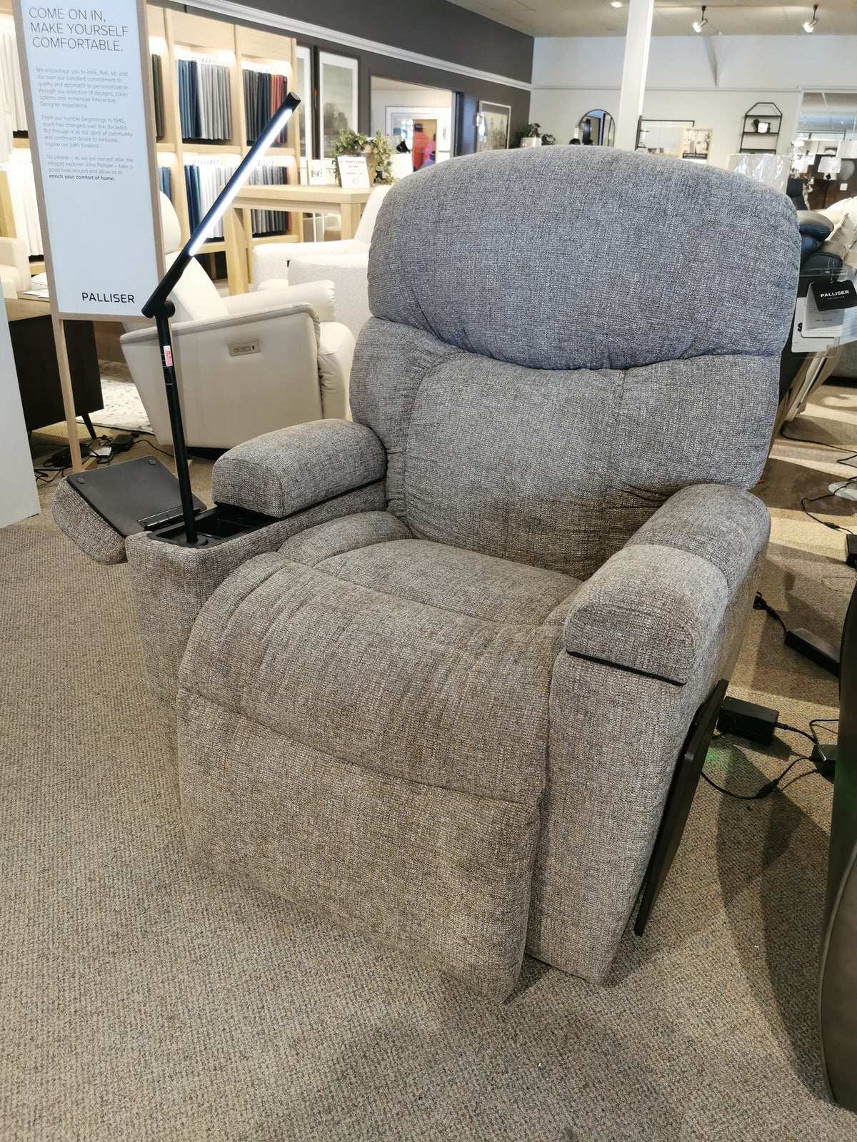 A Maya UC-566 Med Power Lift Chair by Golden, in grey with tray, reading light, and Swedish Air Massage on display.