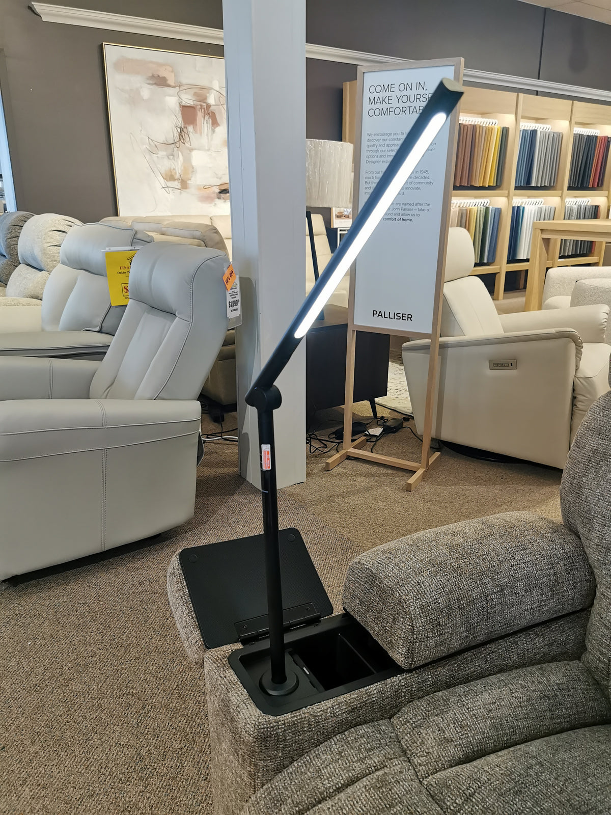 The showroom features Golden's Maya UC-566 Med Power Lift Chair and a modern floor lamp with an adjustable LED light.