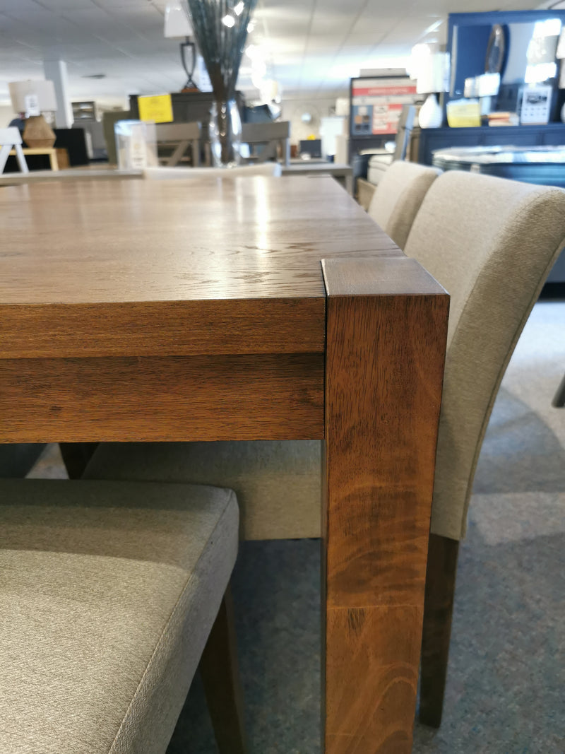 Modern simplicity shines with the Donald Choi Bloc Dining Package in walnut oak veneer at a furniture showroom.