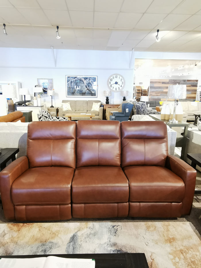 The Muskoka Power Sofa by Aurora Furniture features brown leather and moccasin stitching for an elegant showroom look.