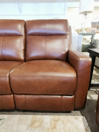 Aurora Furniture's Muskoka Power Sofa in brown leather features moccasin stitching, displayed with carpet and side tables.