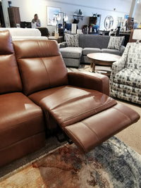 Muskoka Power Sofa by Aurora Furniture: A brown leather reclining sofa with moccasin stitching from the Muskoka Collection.