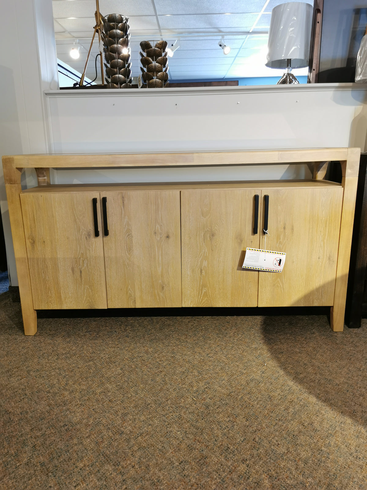 The Magnussen Somerset 64" Sideboard in knotty white oak veneer features bold graphite handles and an open top shelf.