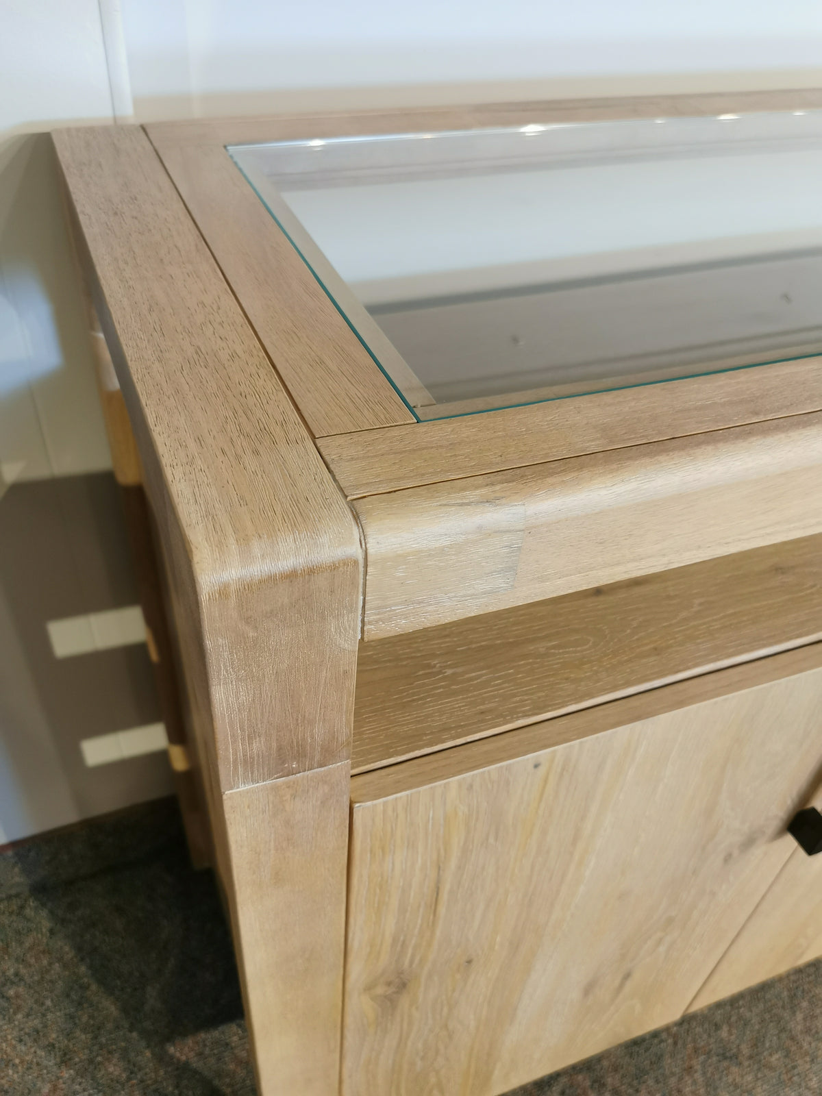 Somerset 64" Sideboard by Magnussen with a glass top, butternut finish, and graphite hardware.