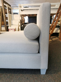 Side view of the 835 Twin DayBed by Vaughan Bassett, featuring light gray upholstery and an oak frame with a bolster cushion.