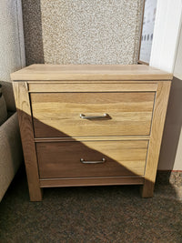 The Vaughan Bassett 830 2-Drawer Nightstand is in solid American white oak, with a natural finish and metallic handles.