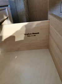 Inside the drawer of the 830 2-Drawer Nightstand, engraved text reads "Vaughan Bassett Made in USA" with a natural finish.