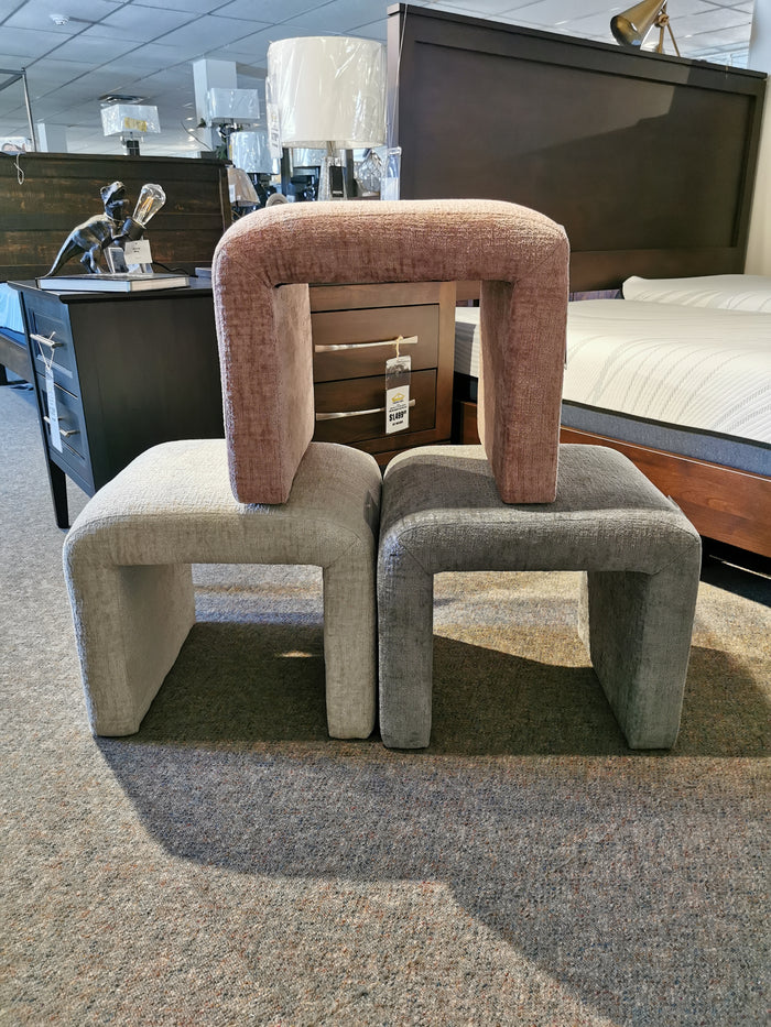 Three Sophia Petite Benches by Jofran in beige, pink, and gray luxe chenille on a carpeted store floor.