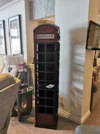 The Jofran Telly Vintage Telephone Booth Bar is a tall, narrow shelf with vintage accents for your furniture collection.