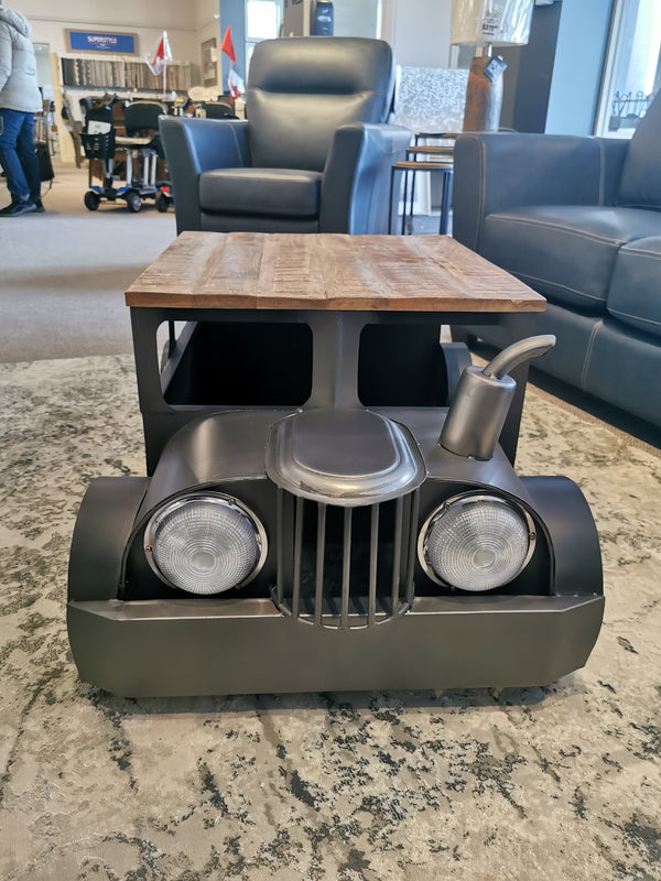 Jofran's 2323 Vintage Car Coffee Table features mango wood and headlights, displayed indoors on a rug.