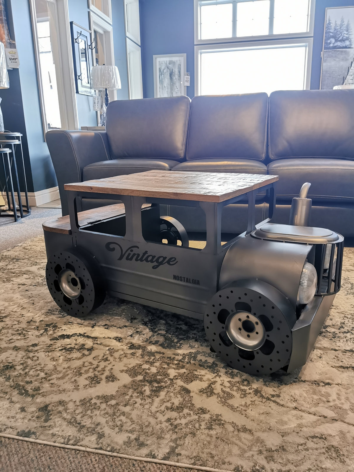 The Jofran 2323 Vintage Car Coffee Table sits beautifully on a patterned rug in the living room.