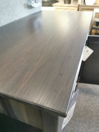 Close-up of the Stockholm Soft Close Sideboard by Handstone, showing indentations on the wooden tabletop against a blurred backdrop.