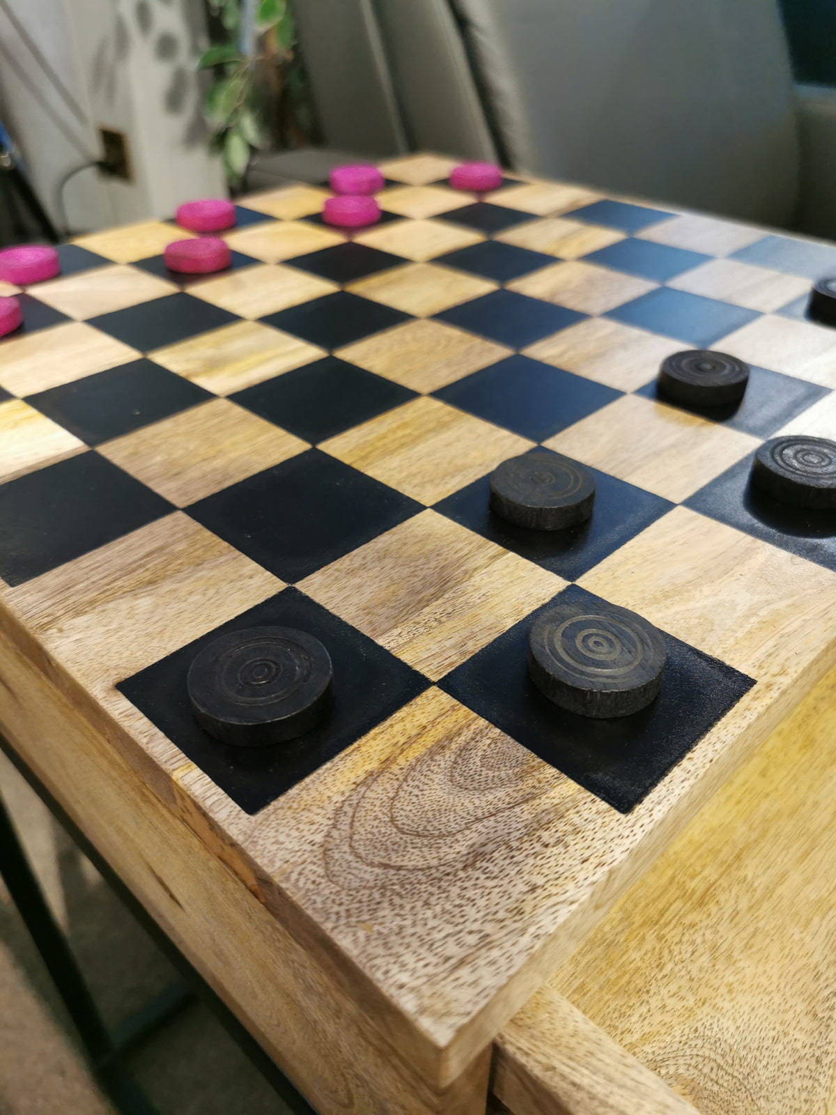 Fairchild Checkerboard C-Table by Jofran features red and brown game pieces on a wooden surface for play.