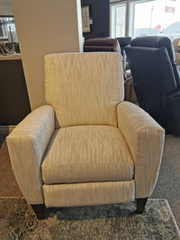 The La-Z-Boy 431 Scarlett High-Leg Recliner, in beige, stands on wooden legs in a carpeted showroom.