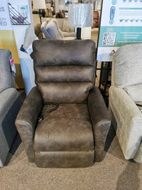 The 786 Liam Lift Chair by La-z-boy, in brown leather, offers a modern look with remote control in a furniture store.