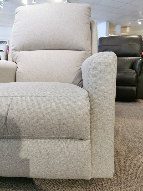 The La-z-boy 700 Wynne Rocker Recliner provides comfort in grey fabric, showcased with furniture on a brown carpet.