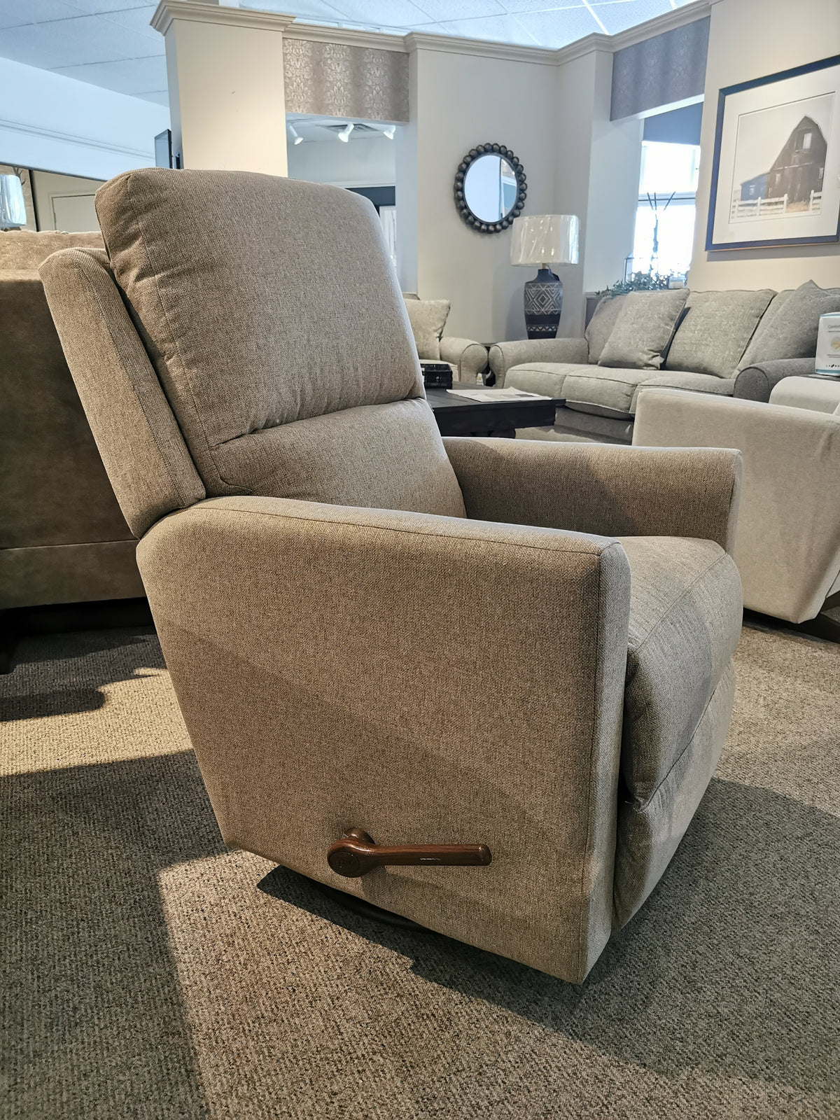 The La-Z-Boy 700 Wynne Swivel Glider recliner with sleek lines is perfect for any living space, shown on a carpeted floor.