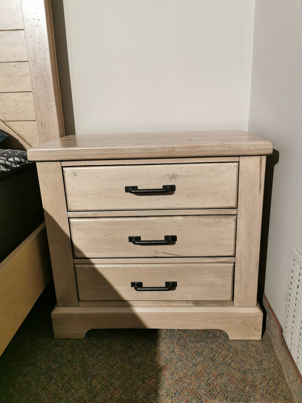 The 176 Cool Rustic Nightstand by Vaughan Bassett boasts solid American White Oak, 3 drawers, and black handles.