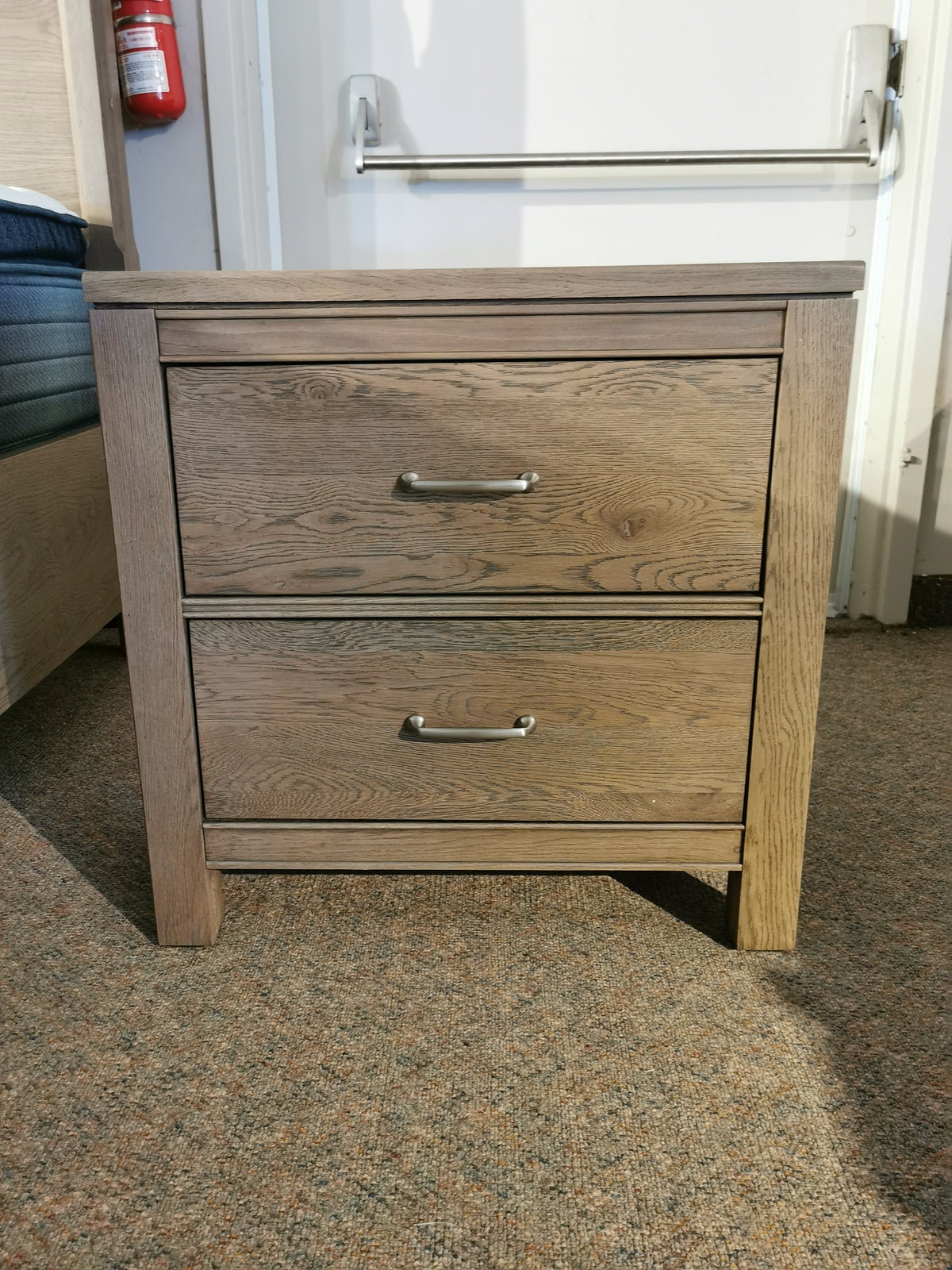 The 831 Tide & Timber Nightstand by Vaughan Bassett casts shadows on a carpeted floor in classic style.