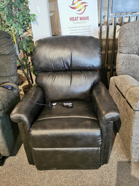 Austin UC-342 Power Lift Chair by Golden in black leather with heat and massage, displayed amid two chairs in the showroom.