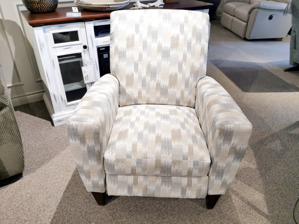 The 431 Scarlett High-Leg Recliner by La-Z-Boy, featuring a patterned beige and white design with wooden legs, is handcrafted in the U.S.A. and elegantly showcased in a showroom.