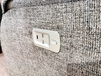 Close-up of a power outlet with a USB port embedded in a textured fabric surface, perfectly complementing the reclining comfort of the luxurious La-Z-Boy 706 Jay Power with Head-Rest Sofa.