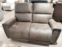 In a store setting, the 757 Apollo Reclining Loveseat by La-z-boy is on display, showcasing its dark brown color with split backs and bucket chaise seats, and surrounded by other stylish furniture items.