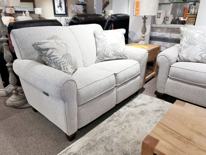 Two La-z-boy 899 Duo Bennett light gray loveseats with patterned cushions, reclining by a wooden side table and lamp.