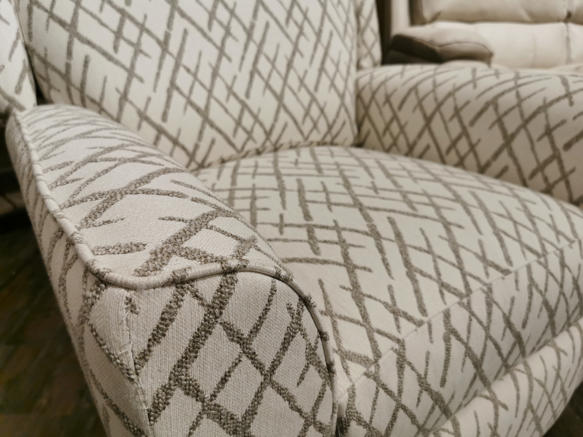 Capture the details of the 458 Rheeves Hi-Leg Recliner by La-Z-Boy, showcasing its beige upholstery adorned with a gray geometric pattern and complemented by stylish decorative wood legs for an elegant touch.